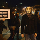 A protester wearing an Anonymous mask looks on as other people demonstrate during a silent protest in the streets of downtown St. Louis on March 14, 2015.
Michael B. Thomas/AFP/Getty Images
